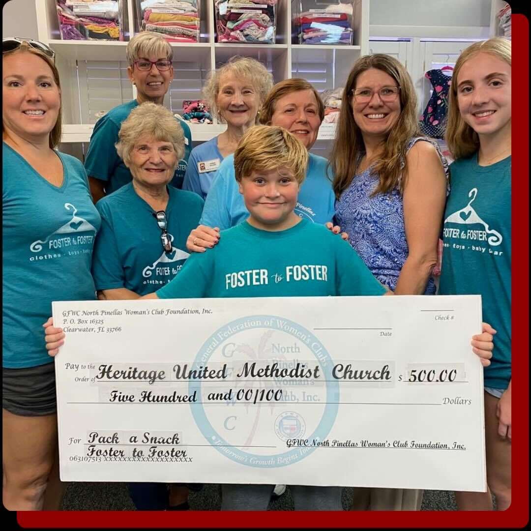 Team picture of the Foster-to-Foster volunteers holding a big $500 check for the Pack a Snack initiative